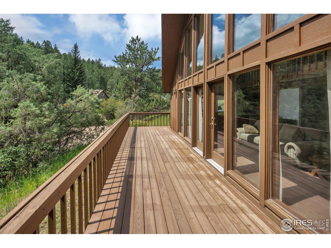 1052 Streamside Drive Drake, CO 80515 - Photo 23 of 31 a balcony with view of outdoor space and wooden deck