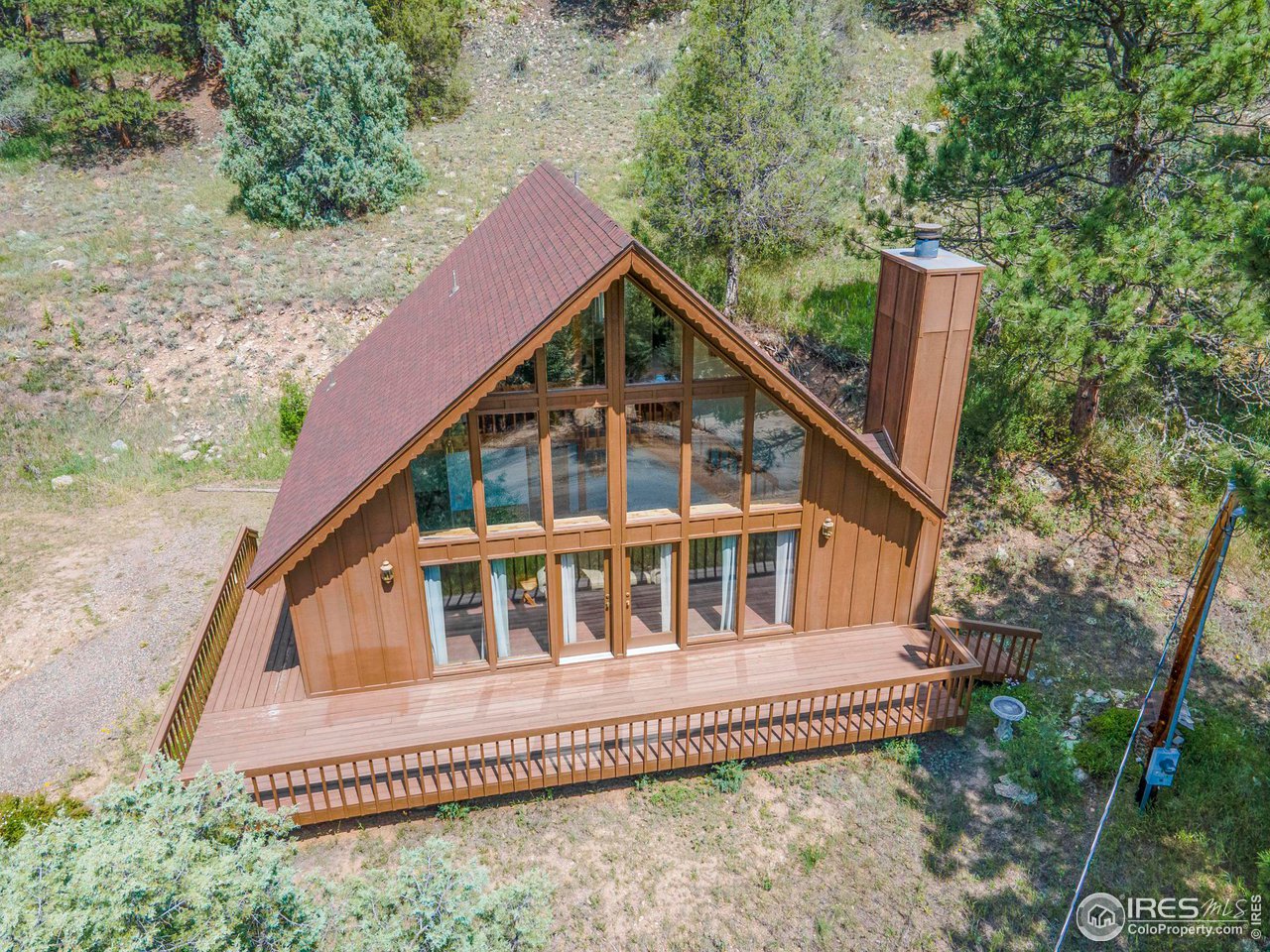 1052 Streamside Drive Drake, CO 80515 - Photo 25 of 31 a house with trees in the background
