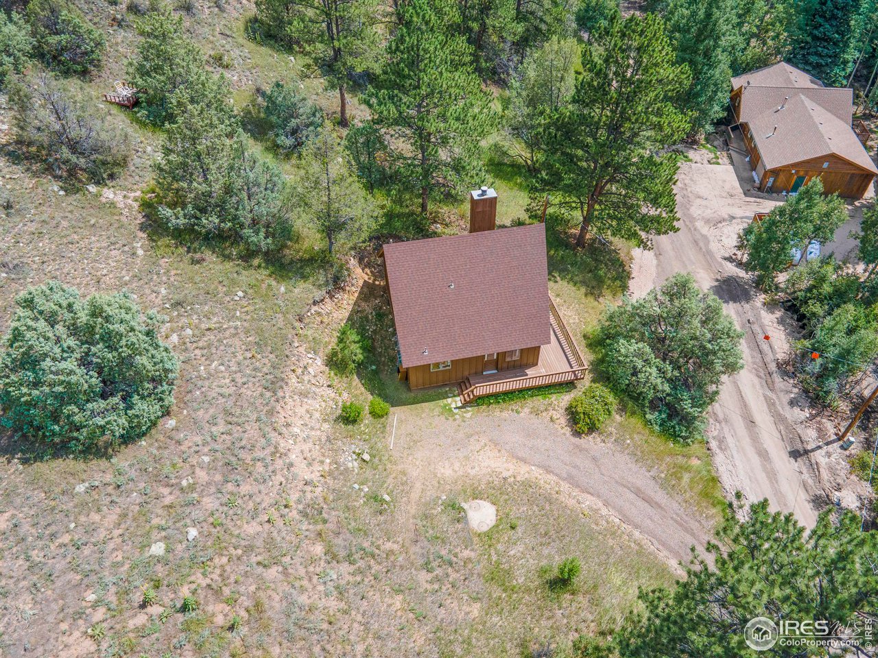 1052 Streamside Drive Drake, CO 80515 - Photo 27 of 31 an aerial view of a house with a yard and greenery
