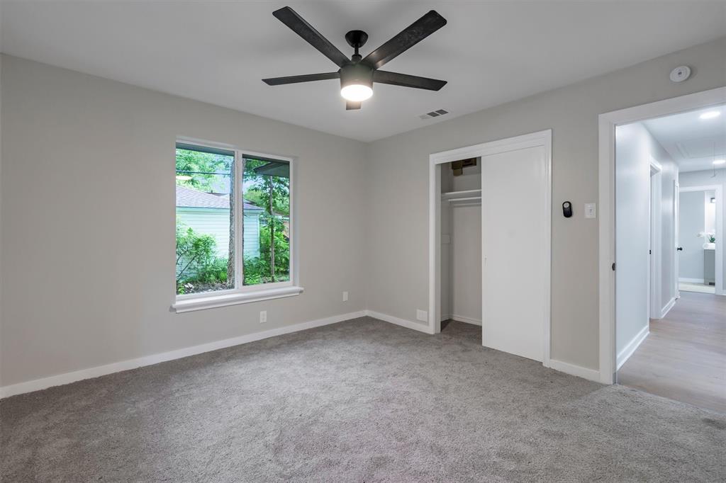 4815 Kelman Street Dallas, TX 75214 - Photo 26 of 37 Carpeted room with a ceiling fan, a window, and a built-in closet with sliding doors