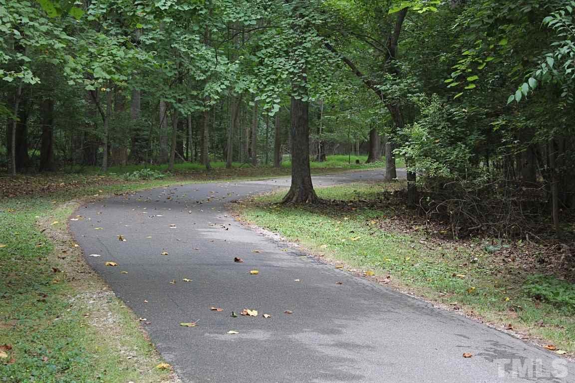 2720 Dahlgreen Road Raleigh, NC 27615 - Photo 22 of 25 a view of a tree in the middle of a yard