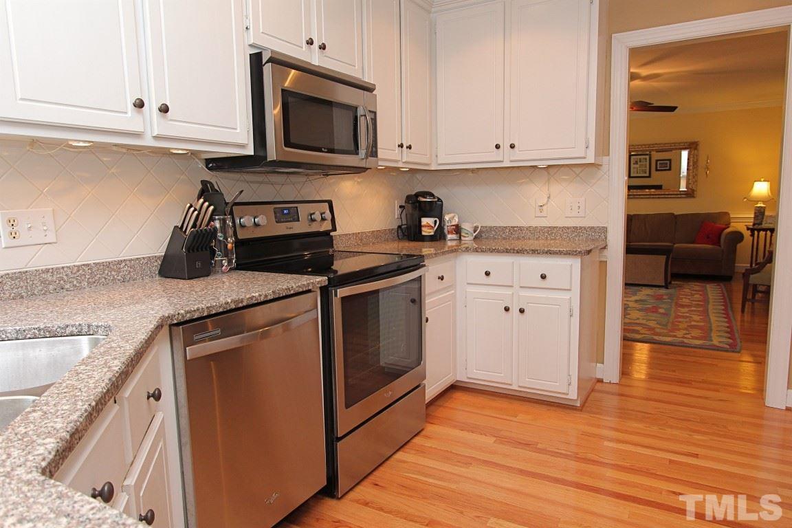 2720 Dahlgreen Road Raleigh, NC 27615 - Photo 6 of 25 a kitchen with granite countertop cabinets stainless steel appliances and wooden floor
