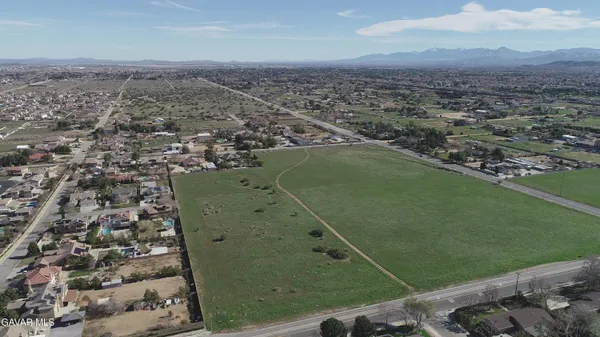 an aerial view of a residential houses with outdoor space