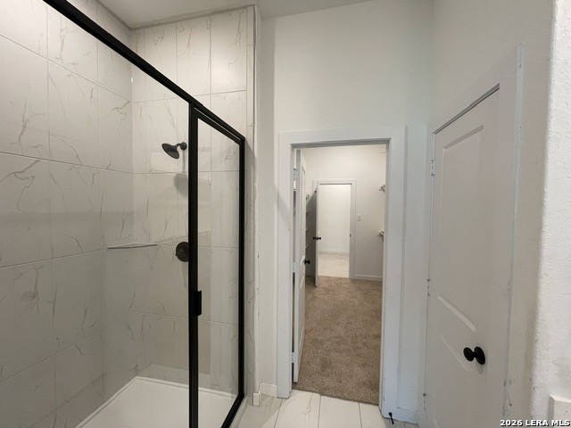 9431 Hidden Stone Schertz, TX 78154 - Photo 14 of 30 a bathroom with a shower and a glass door