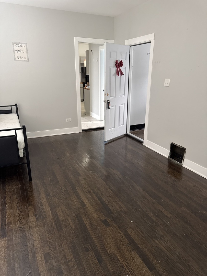 310 West 105th Street Chicago, IL 60628 - Photo 16 of 22 an empty room with wooden floor and closet