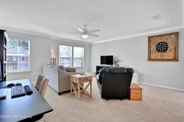 a living room with furniture and a large window