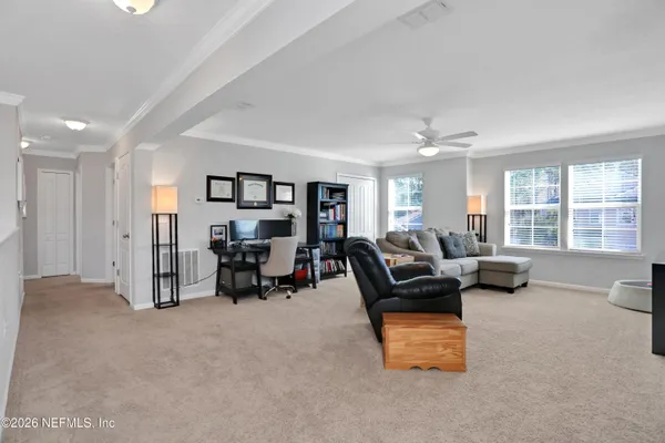 a spacious bedroom with a bed and a chandelier