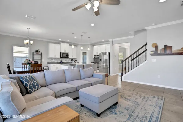 a living room with furniture and kitchen view