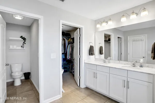 a spacious bathroom with a granite countertop tub sink a mirror and shower