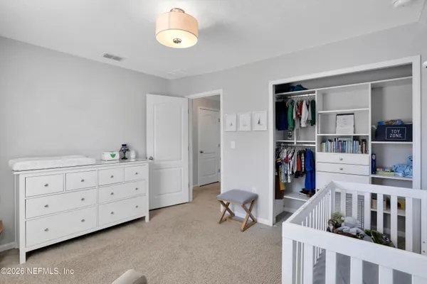 a view of a bedroom with furniture and windows