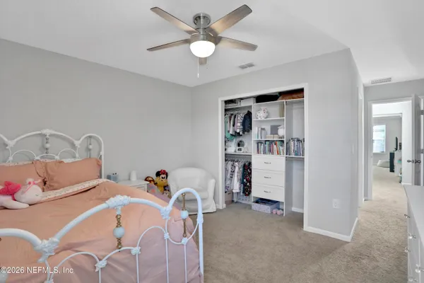 a bedroom with bed and window