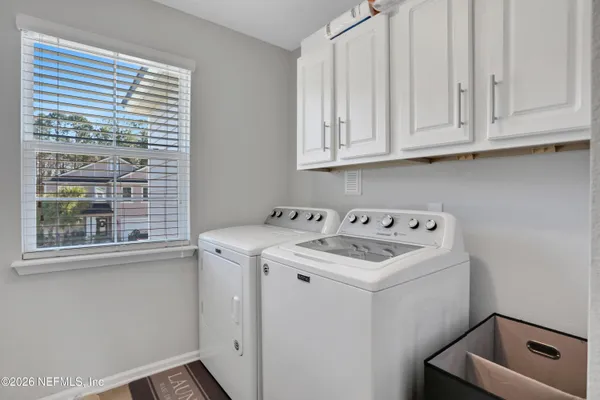 a kitchen with granite countertop a sink stainless steel appliances and white cabinets