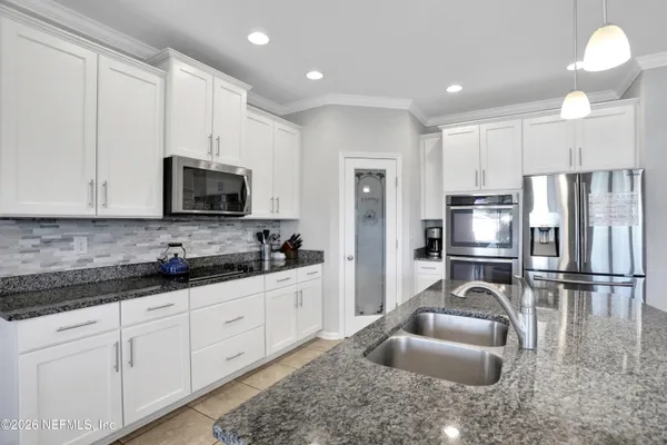 a kitchen with stainless steel appliances kitchen island granite countertop a sink and cabinets