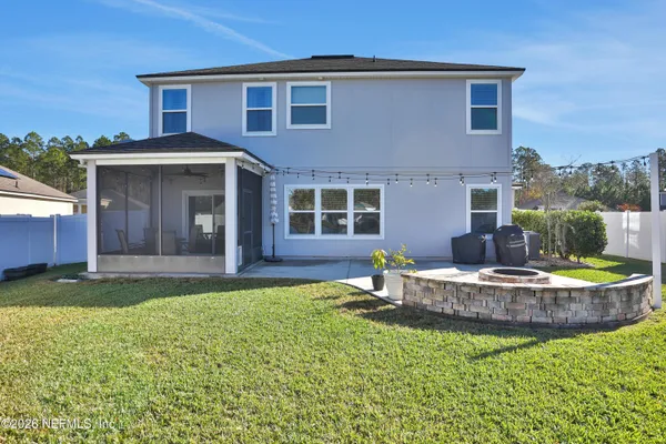 a view of a house with a yard and sitting area