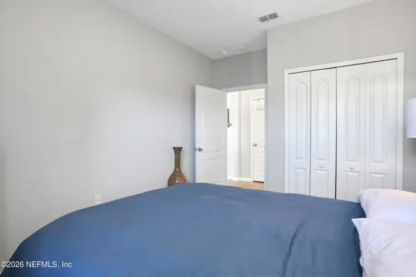 a bedroom with a bed and a closet