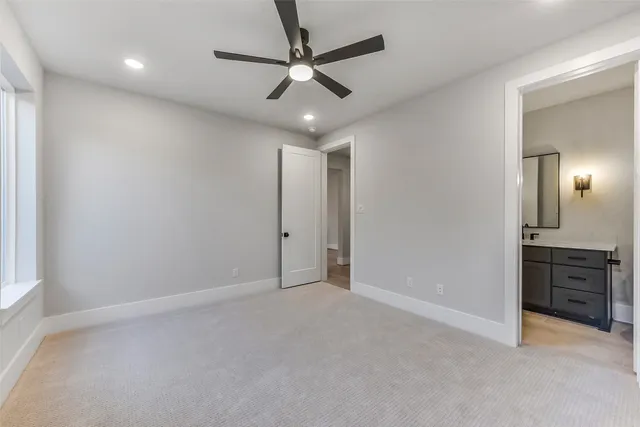 an empty room with closet and fan