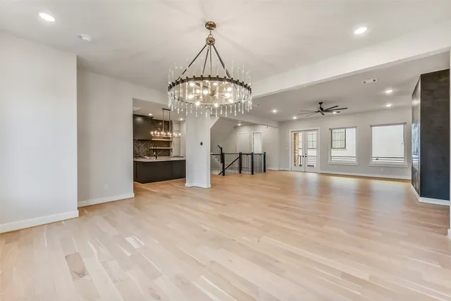 a view of a livingroom with a furniture chandelier wooden floor and a chandelier