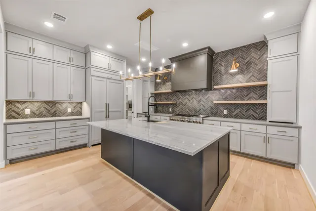 a kitchen with a sink stove and refrigerator