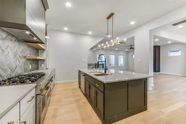 a kitchen with stainless steel appliances a sink and stove