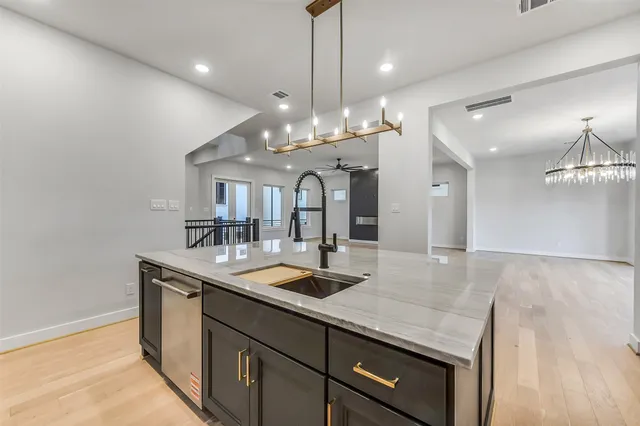 a view of a kitchen counter a sink and chandelier