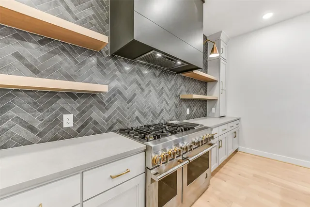a white stove top oven sitting inside of a kitchen
