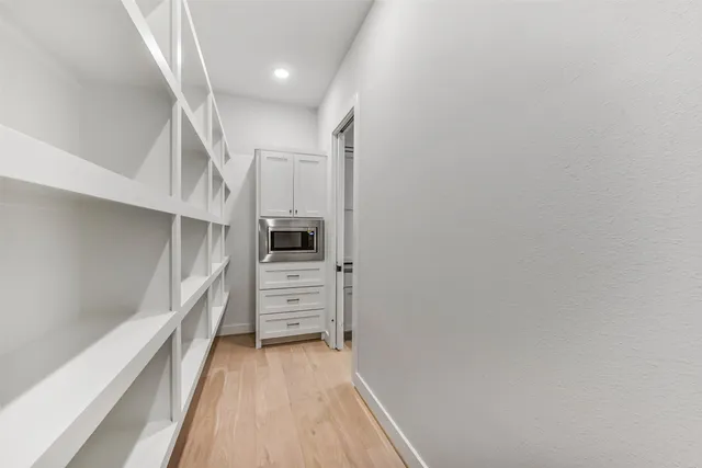 a view of hallway with stairs and wooden floor