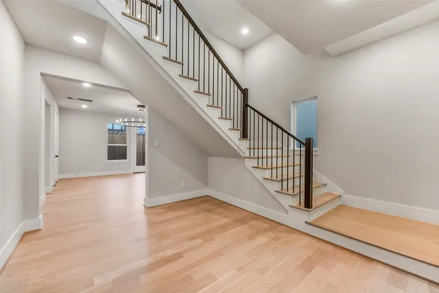 a view of staircase with white walls and a window