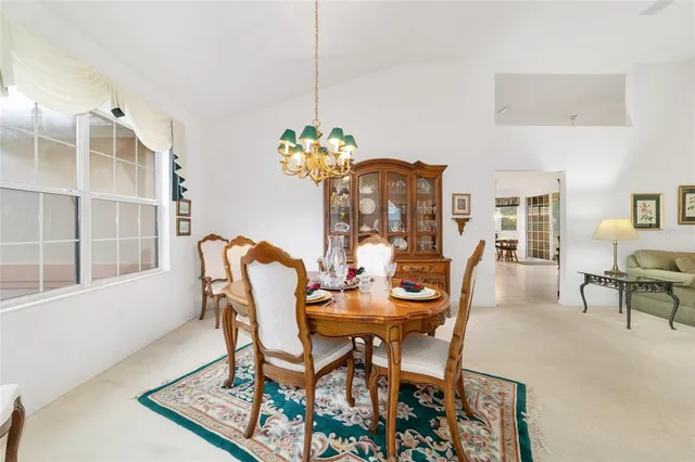 a kitchen with a stove a table and chairs in it