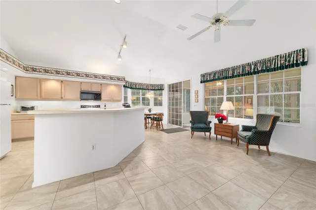 a kitchen with stainless steel appliances a refrigerator sink and stove top oven