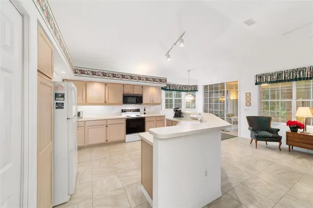 a living room with furniture and large windows