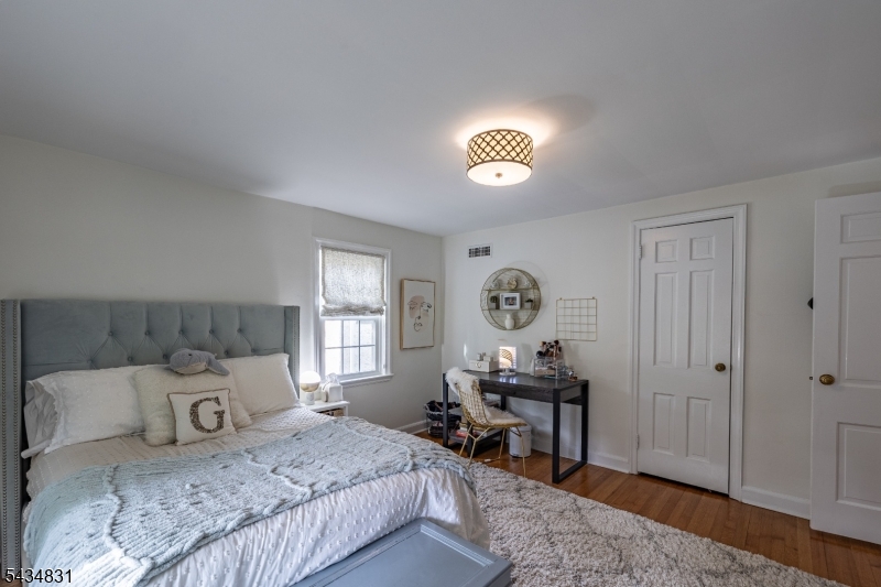 200 Wychwood Road Westfield, NJ 07090 - Photo 21 of 31 a bedroom with a bed and a table in it