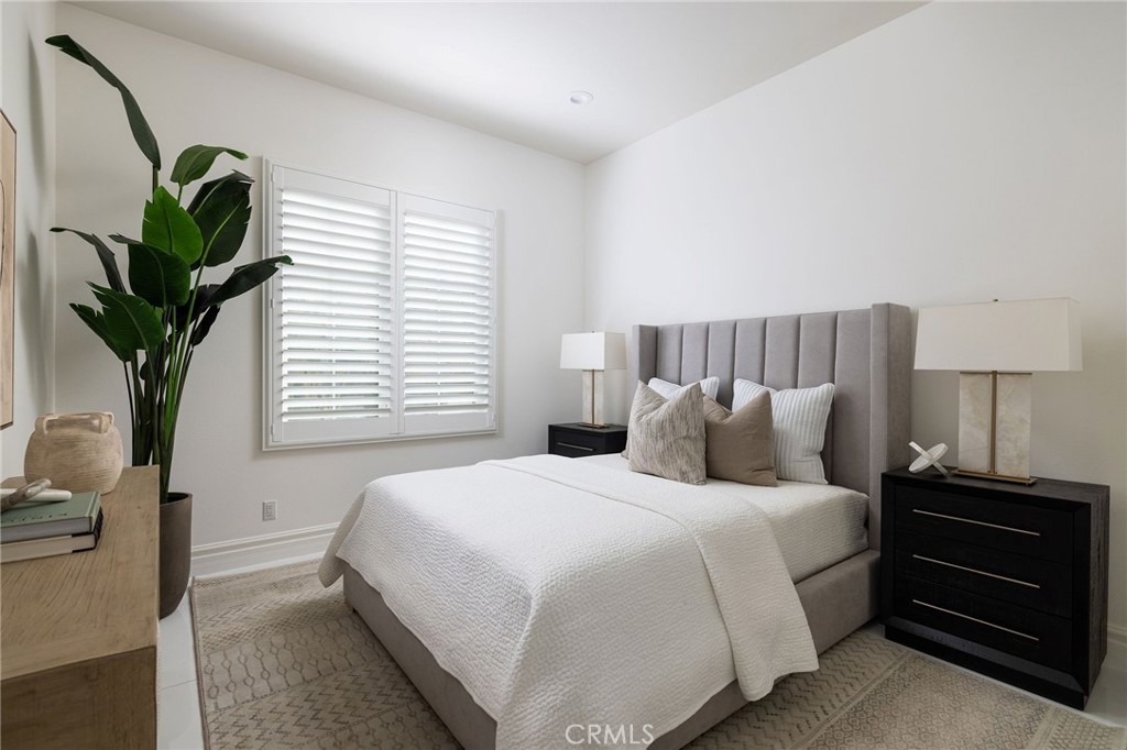 104 Interstellar Irvine, CA 92618 - Photo 25 of 52 a bedroom with bed and a potted plant