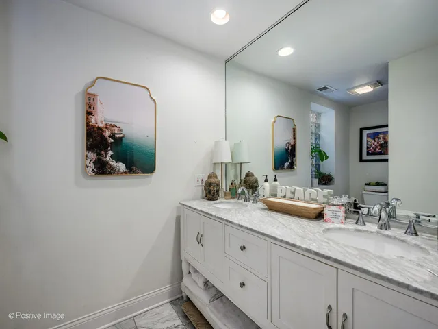 a bathroom with a double vanity sink and a mirror