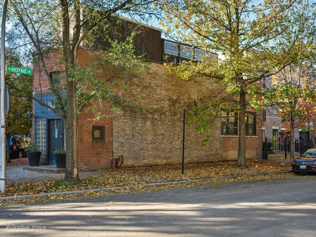 a view of a brick house next to a road