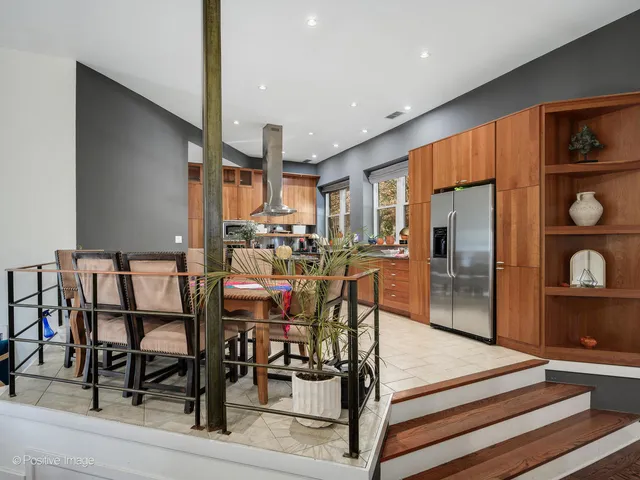 a kitchen with stainless steel appliances kitchen island granite countertop a refrigerator and cabinets