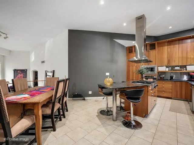 a kitchen with a dining table and chairs