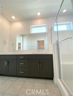 402 Transport Tustin, CA 92782 - Photo 18 of 26 a bathroom with a granite countertop double vanity sink and a mirror