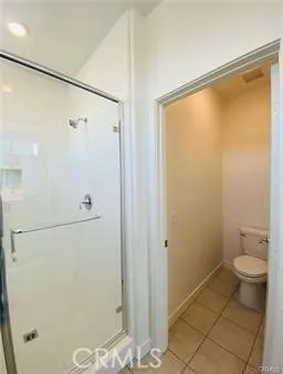a bathroom with a shower and a toilet