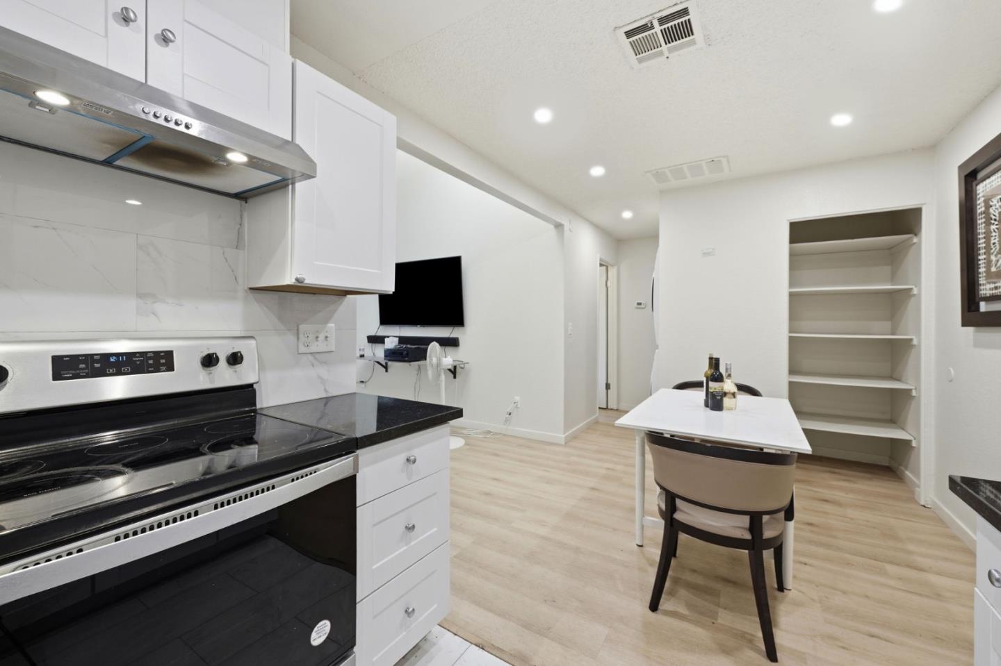 7283 Florin Road, Unit 8 Sacramento, CA 95828 - Photo 18 of 35 a kitchen with a stove cabinets and a wooden floor