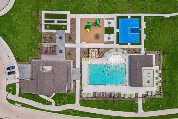 an aerial view of a house with a garden and lake view