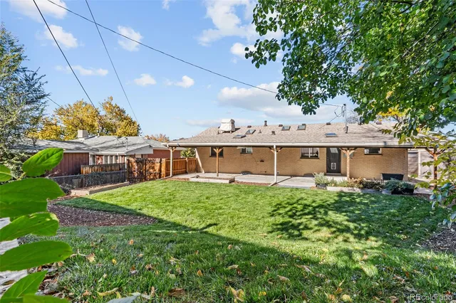 a view of a house with a big yard and potted plants
