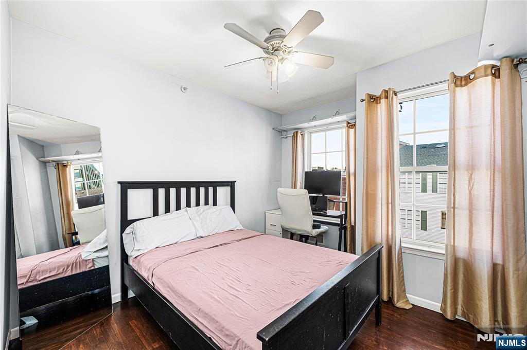 84 Union Street Newark, NJ 07105 - Photo 27 of 39 a bedroom with a large bed and a chandelier