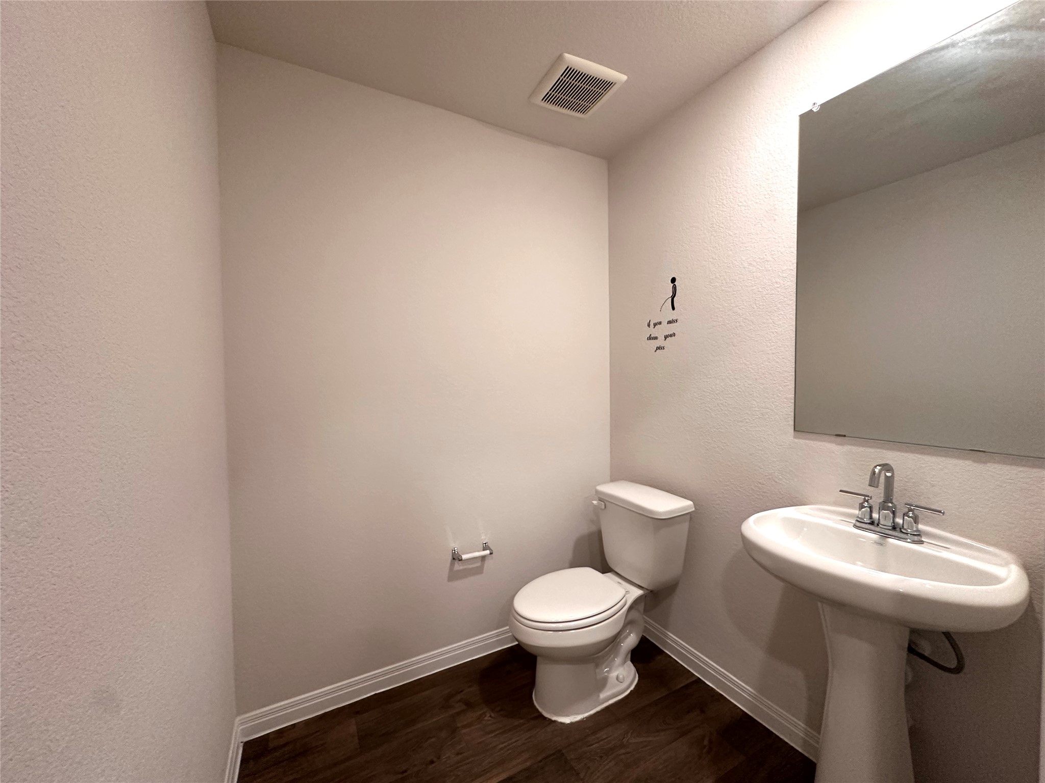 13804 Thomas Wheeler Way Manor, TX 78653 - Photo 11 of 27 Bathroom featuring a textured wall and dark wood-style flooring