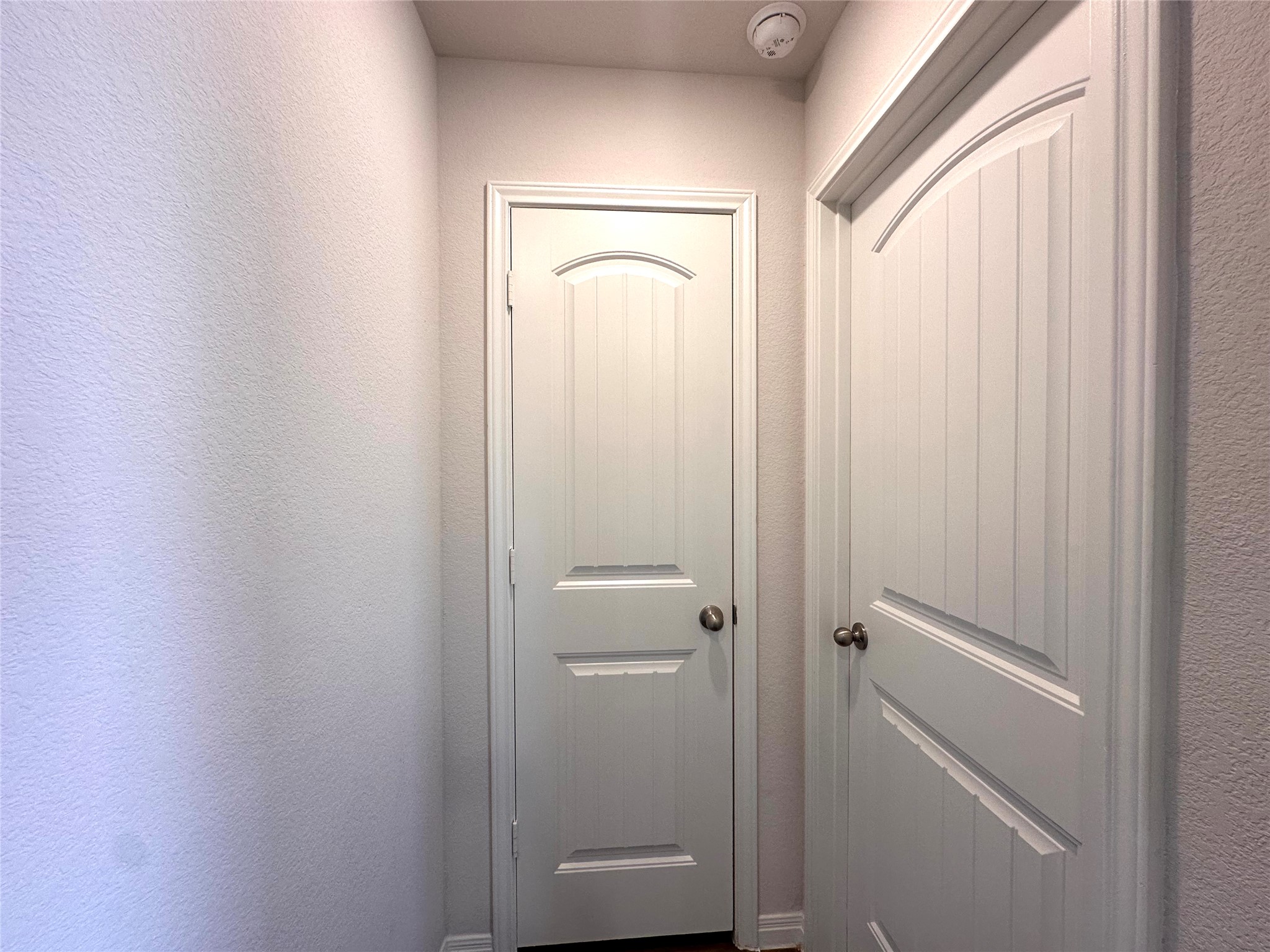 13804 Thomas Wheeler Way Manor, TX 78653 - Photo 15 of 27 Doorway with a textured wall and baseboards