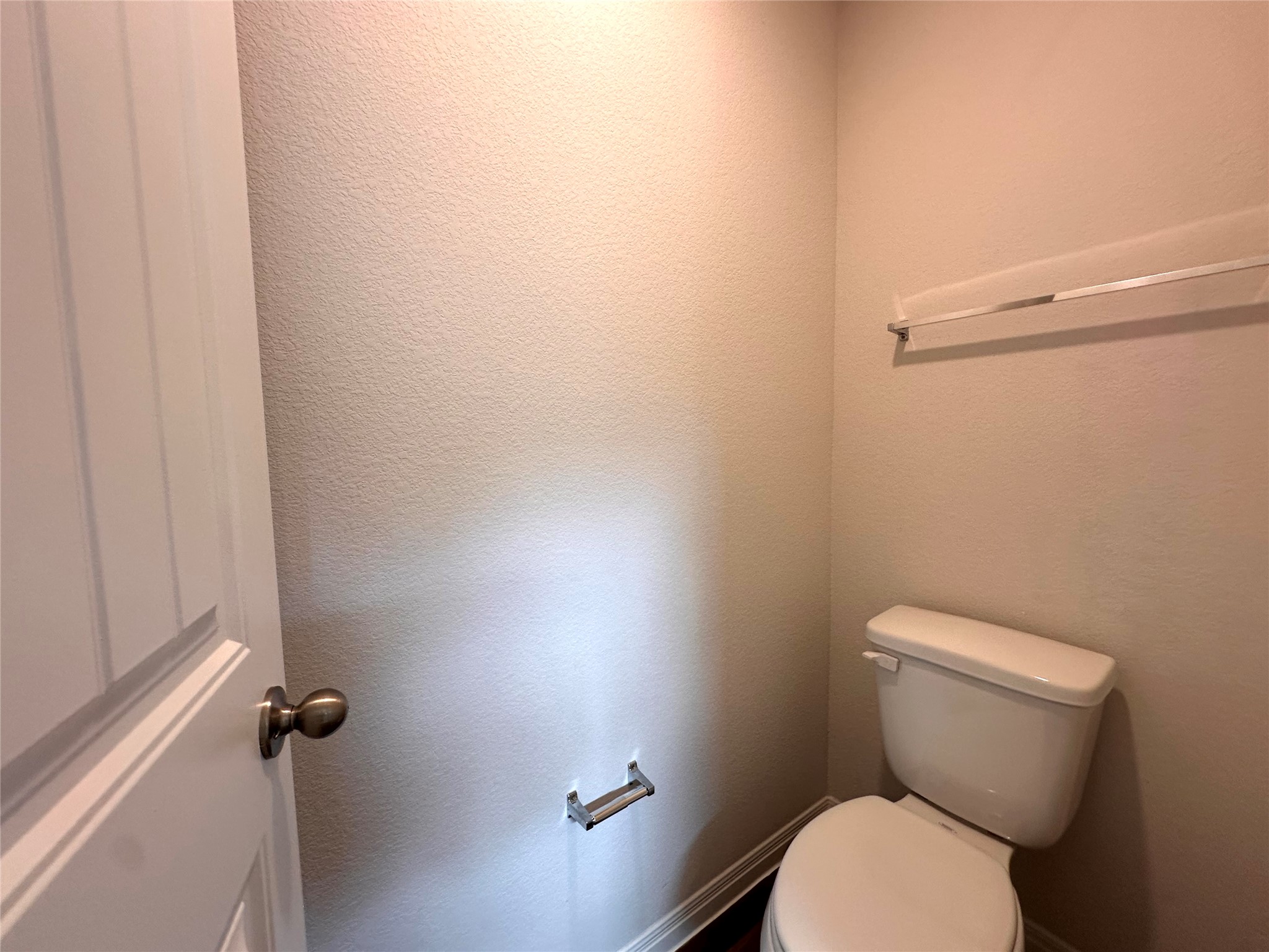 13804 Thomas Wheeler Way Manor, TX 78653 - Photo 20 of 27 Bathroom with toilet and a textured wall