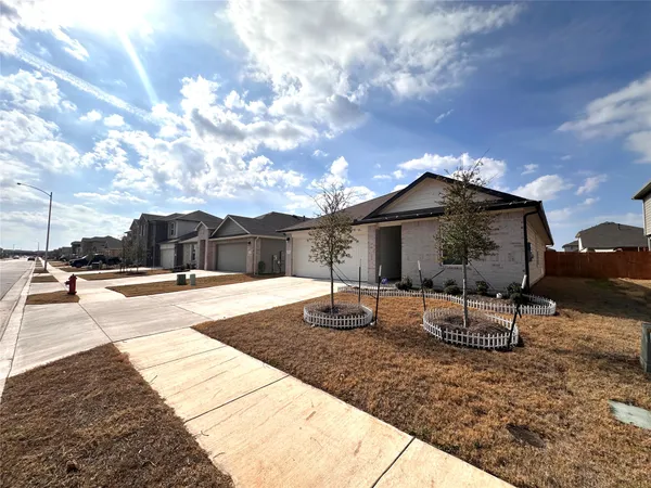 a view of a house with backyard and sitting area