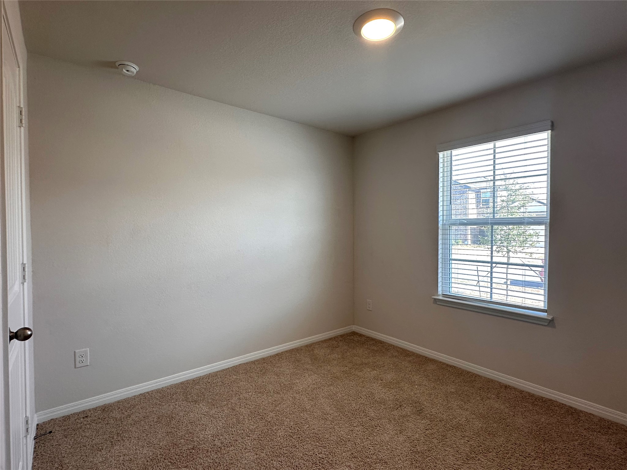 13804 Thomas Wheeler Way Manor, TX 78653 - Photo 6 of 27 Spare room featuring baseboards and carpet