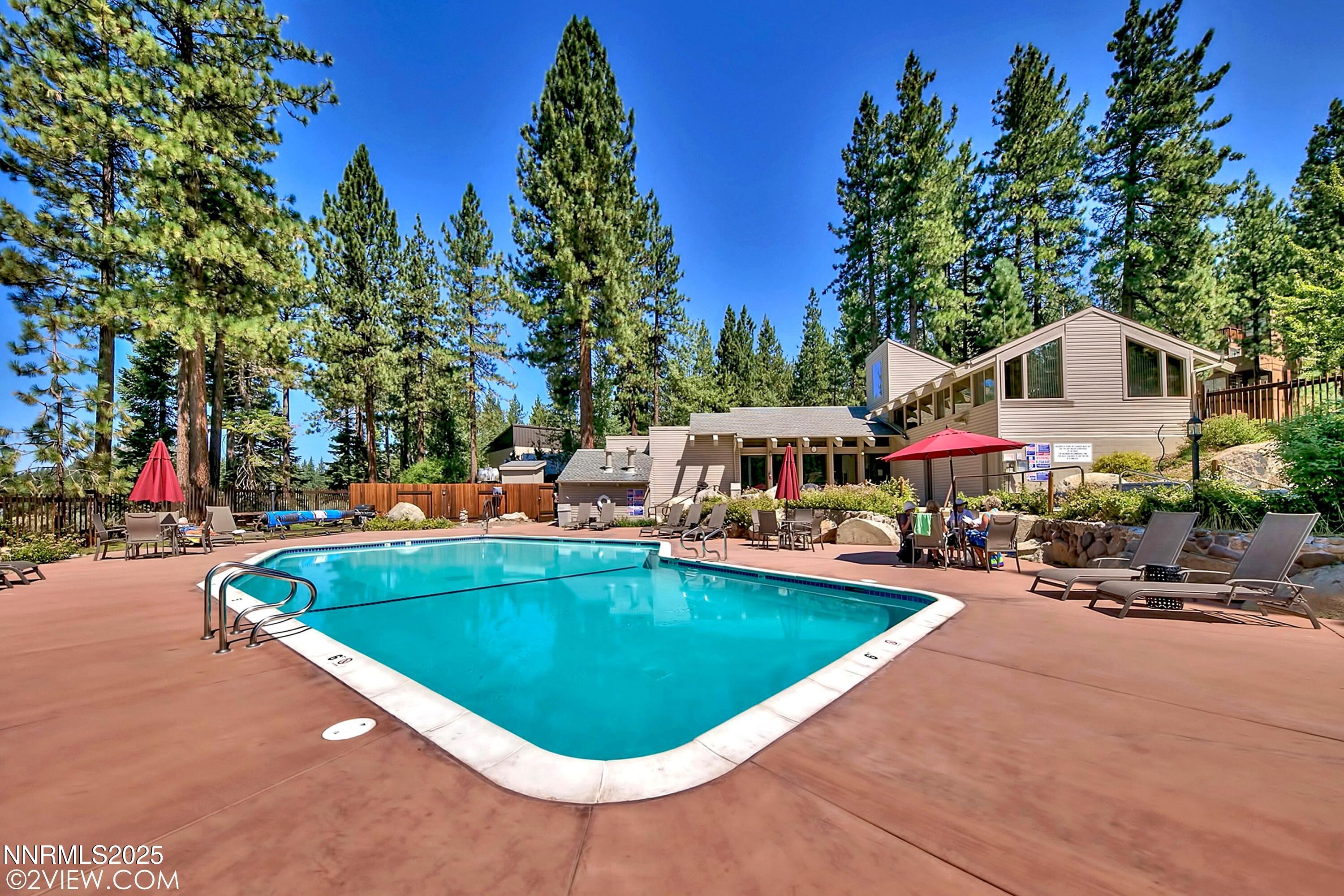 205 Clubhouse Circle Stateline, NV 89449 - Photo 23 of 27 a swimming pool with outdoor seating and yard