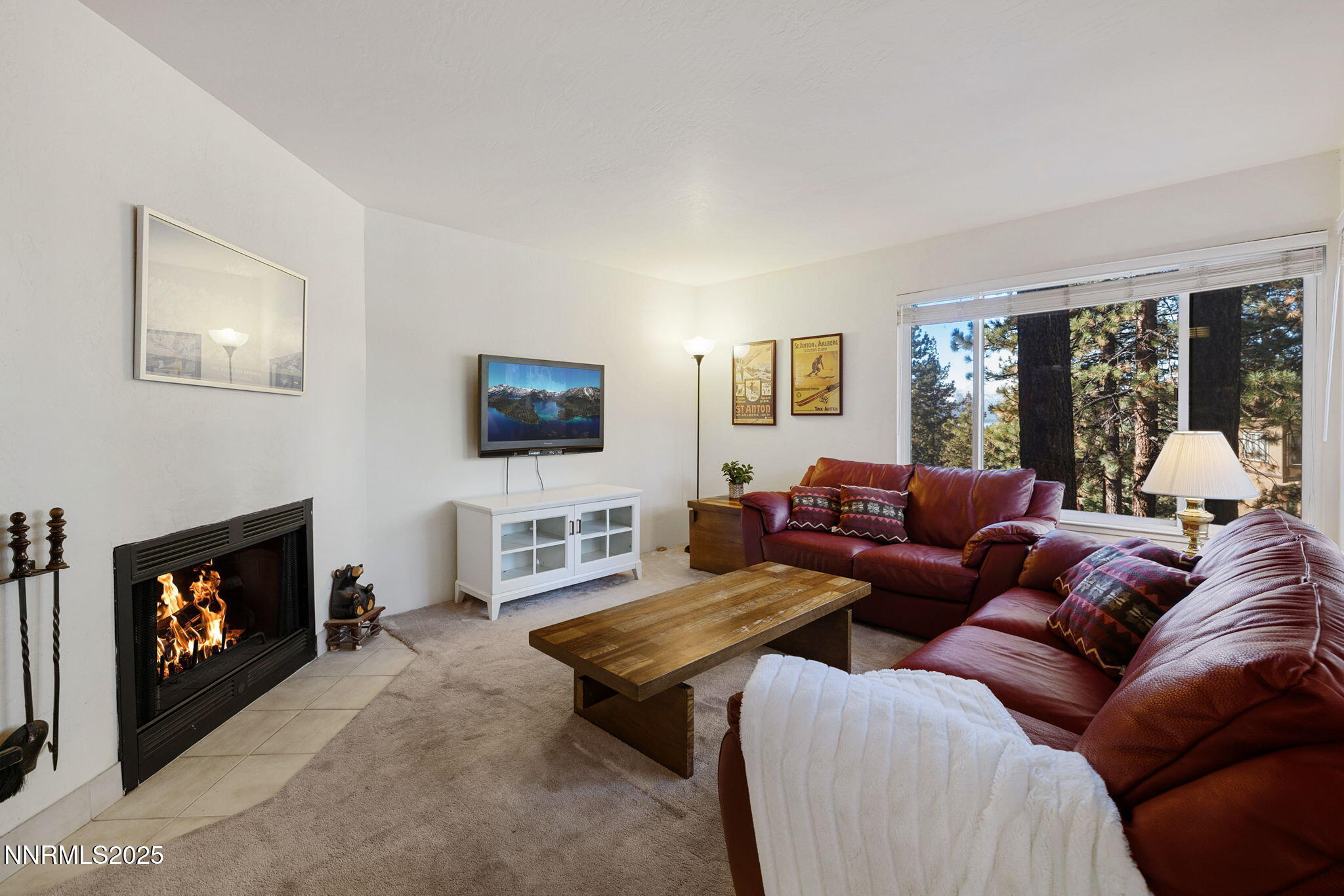 205 Clubhouse Circle Stateline, NV 89449 - Photo 3 of 27 a living room with furniture a flat screen tv and a fireplace