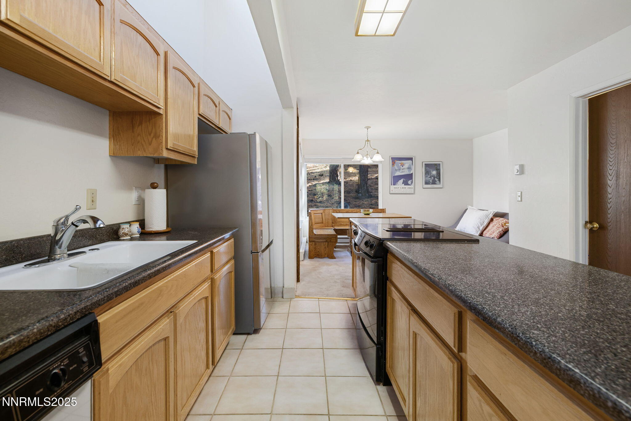 205 Clubhouse Circle Stateline, NV 89449 - Photo 10 of 27 a kitchen with stainless steel appliances granite countertop a sink stove and refrigerator